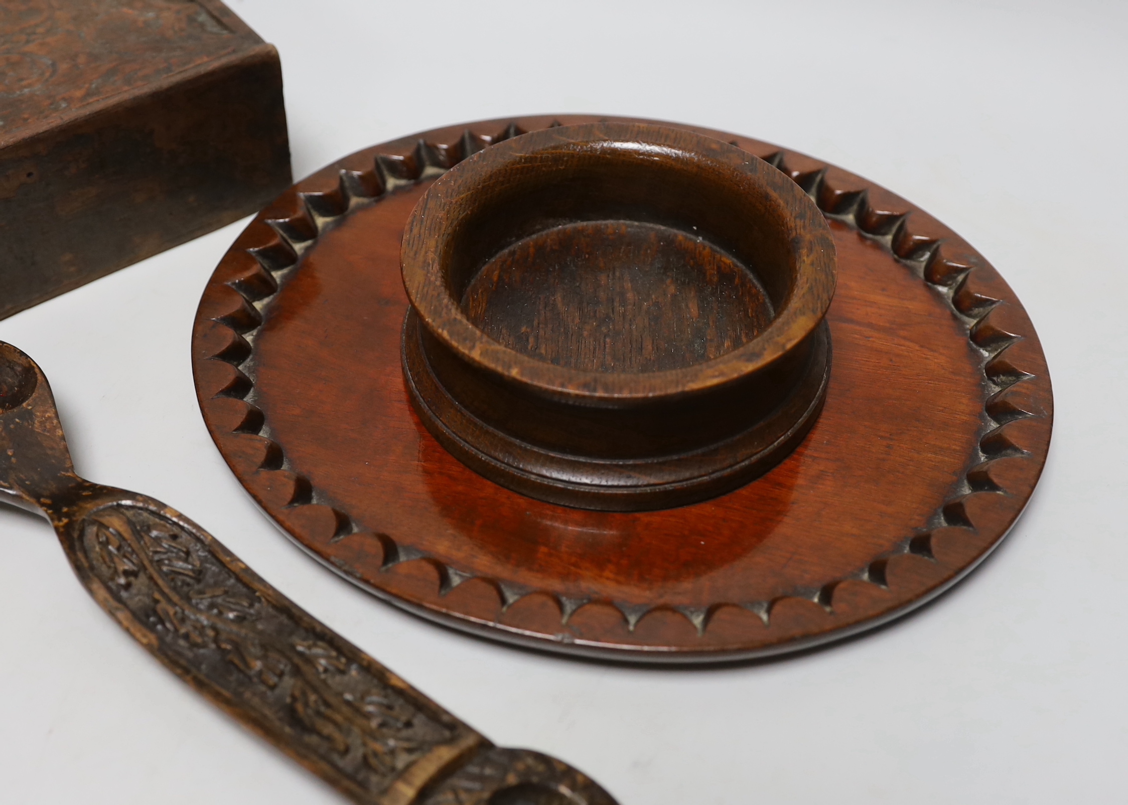 Treen including carved love spoon, four section box with incised decoration and a coaster, the largest 27cm wide